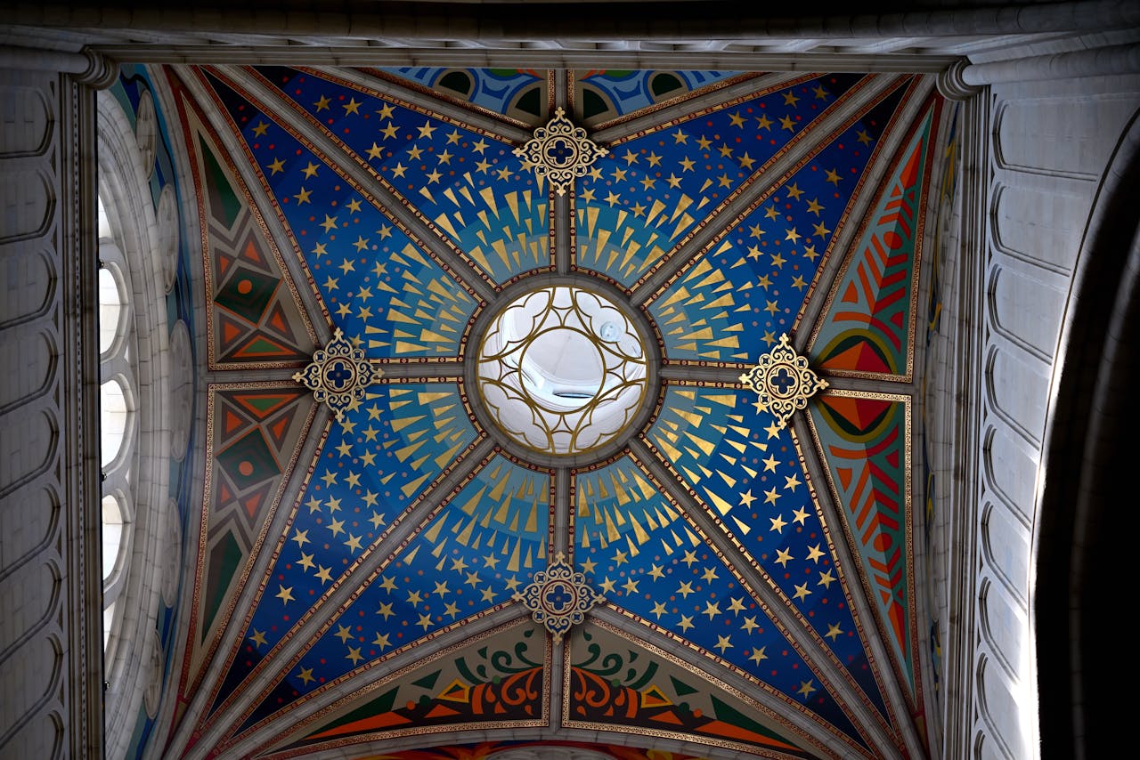 Beautiful stained glass ceiling with intricate patterns and vibrant colors in a historic building.